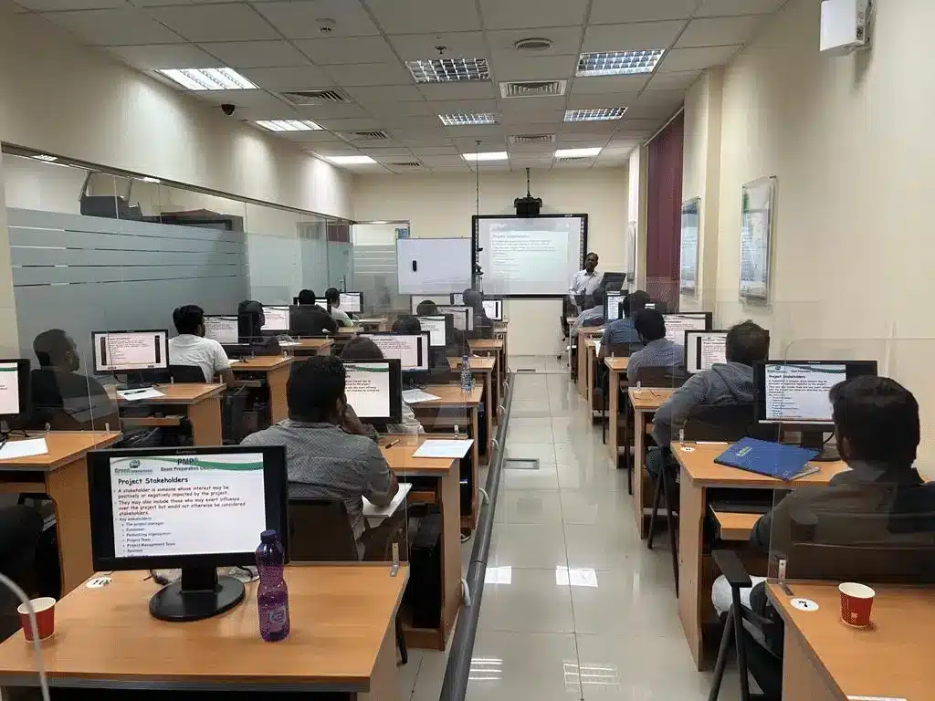 Candidates studying at computers in a Green International training room