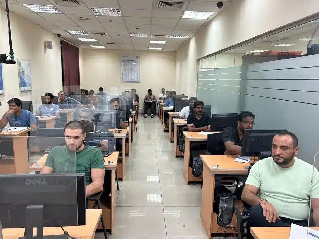 Candidates at computer stations in a Green International exam hall